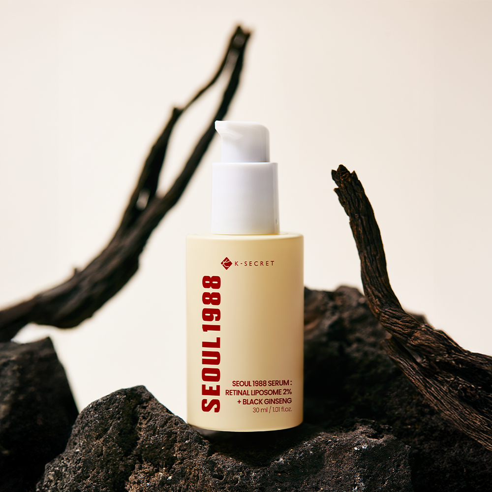 Golden serum drops on hand